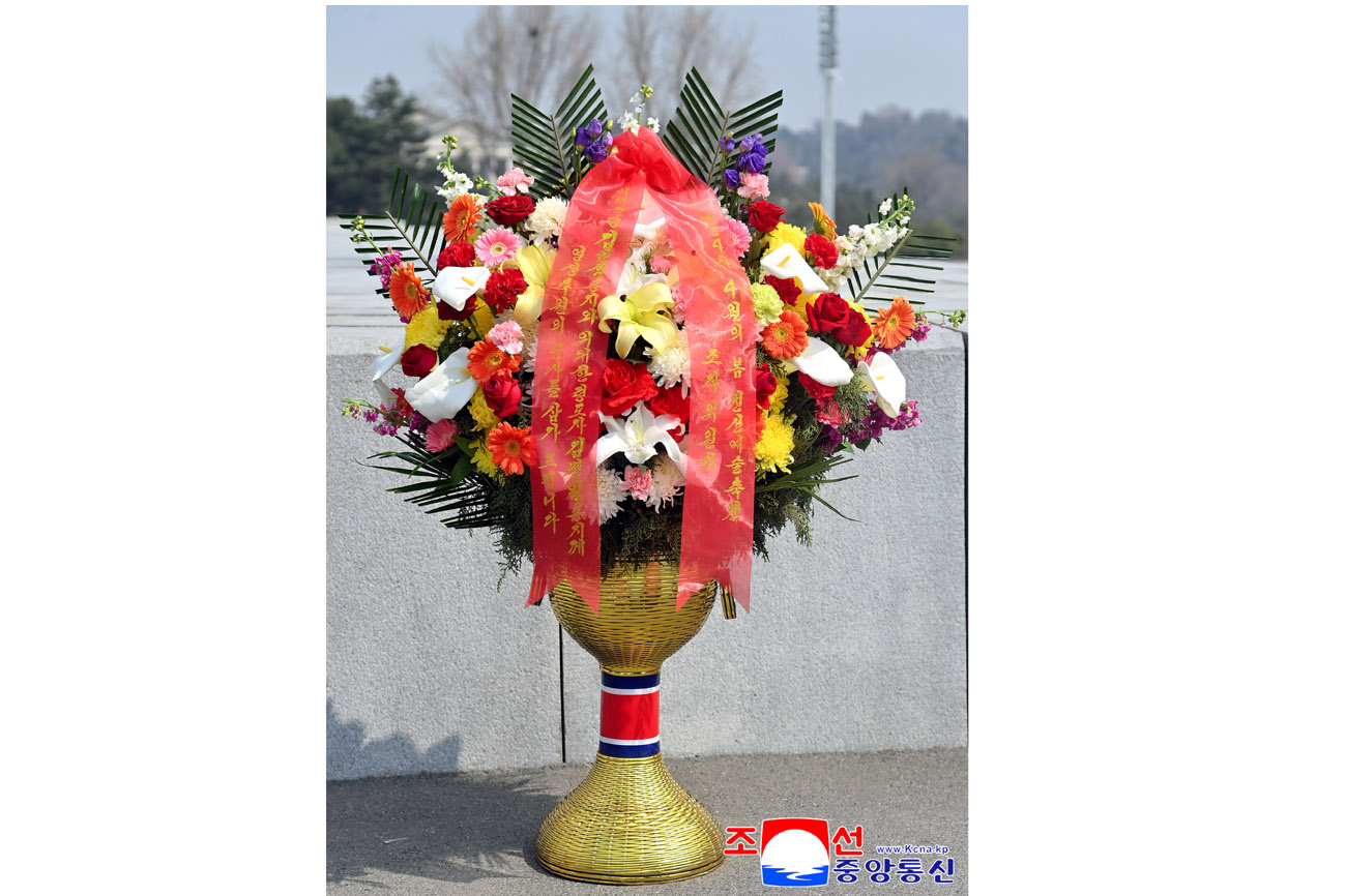 Floral baskets laid before bronze statues of great leaders Kim Il Sung and Kim Jong Il