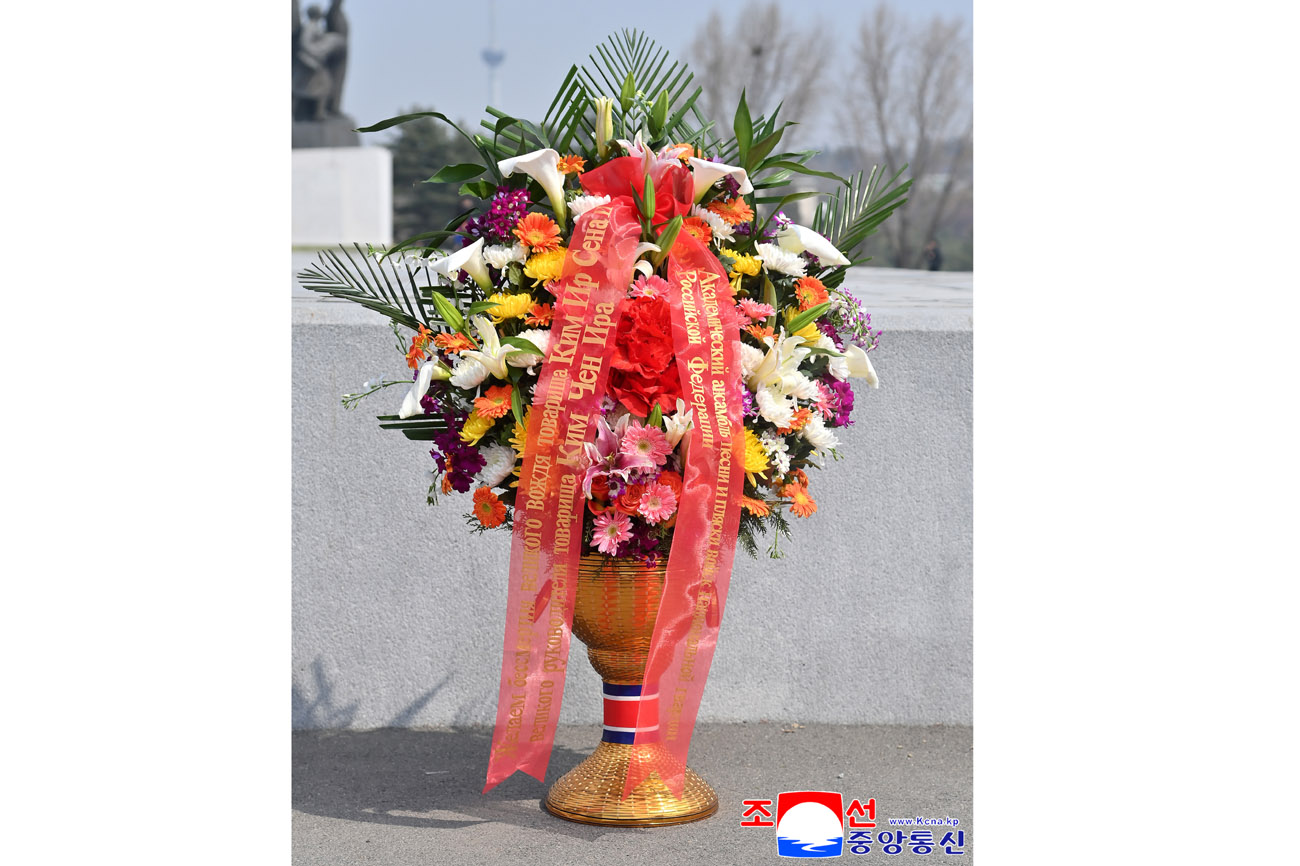 Floral baskets laid before bronze statues of great leaders Kim Il Sung and Kim Jong Il