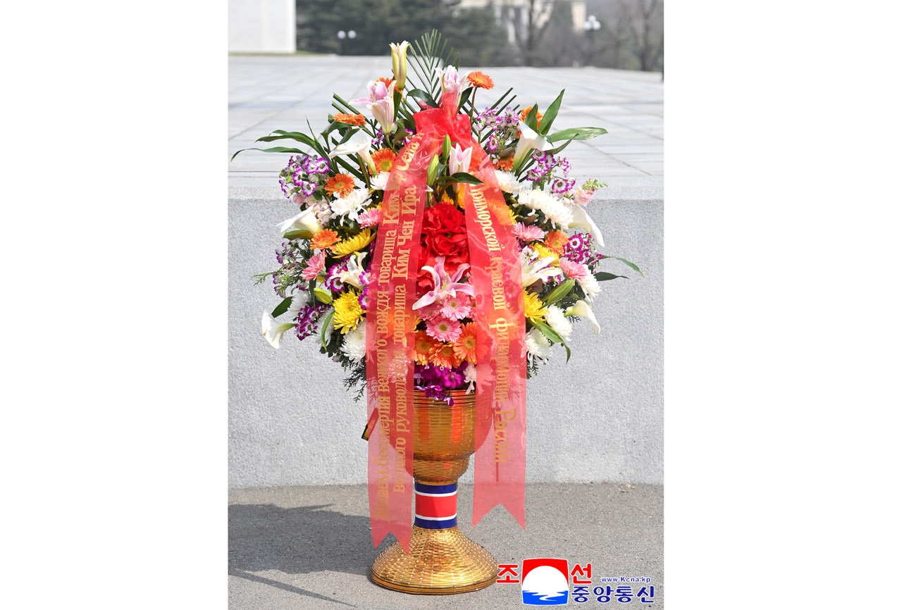 Floral baskets laid before bronze statues of great leaders Kim Il Sung and Kim Jong Il