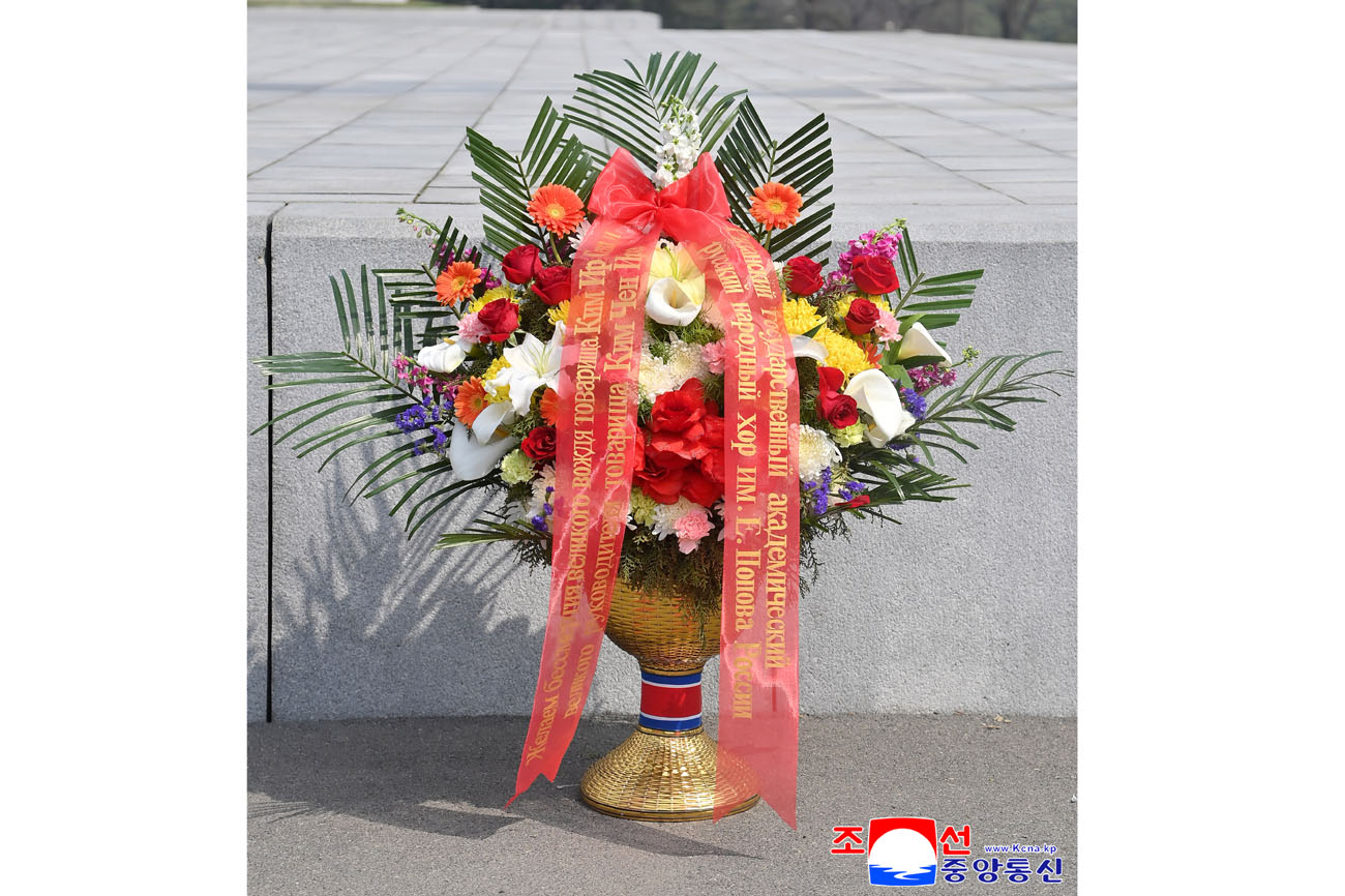 Floral baskets laid before bronze statues of great leaders Kim Il Sung and Kim Jong Il