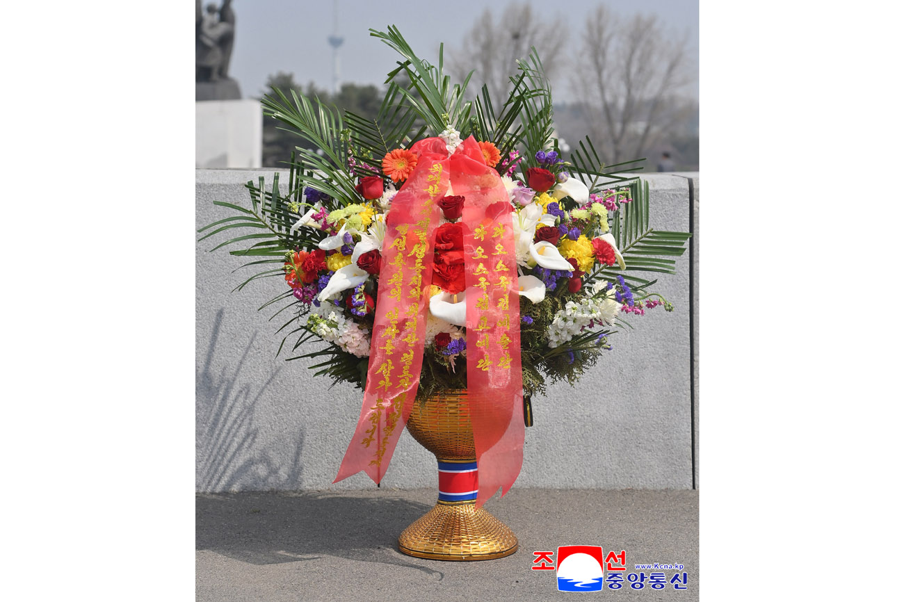 Floral baskets laid before bronze statues of great leaders Kim Il Sung and Kim Jong Il