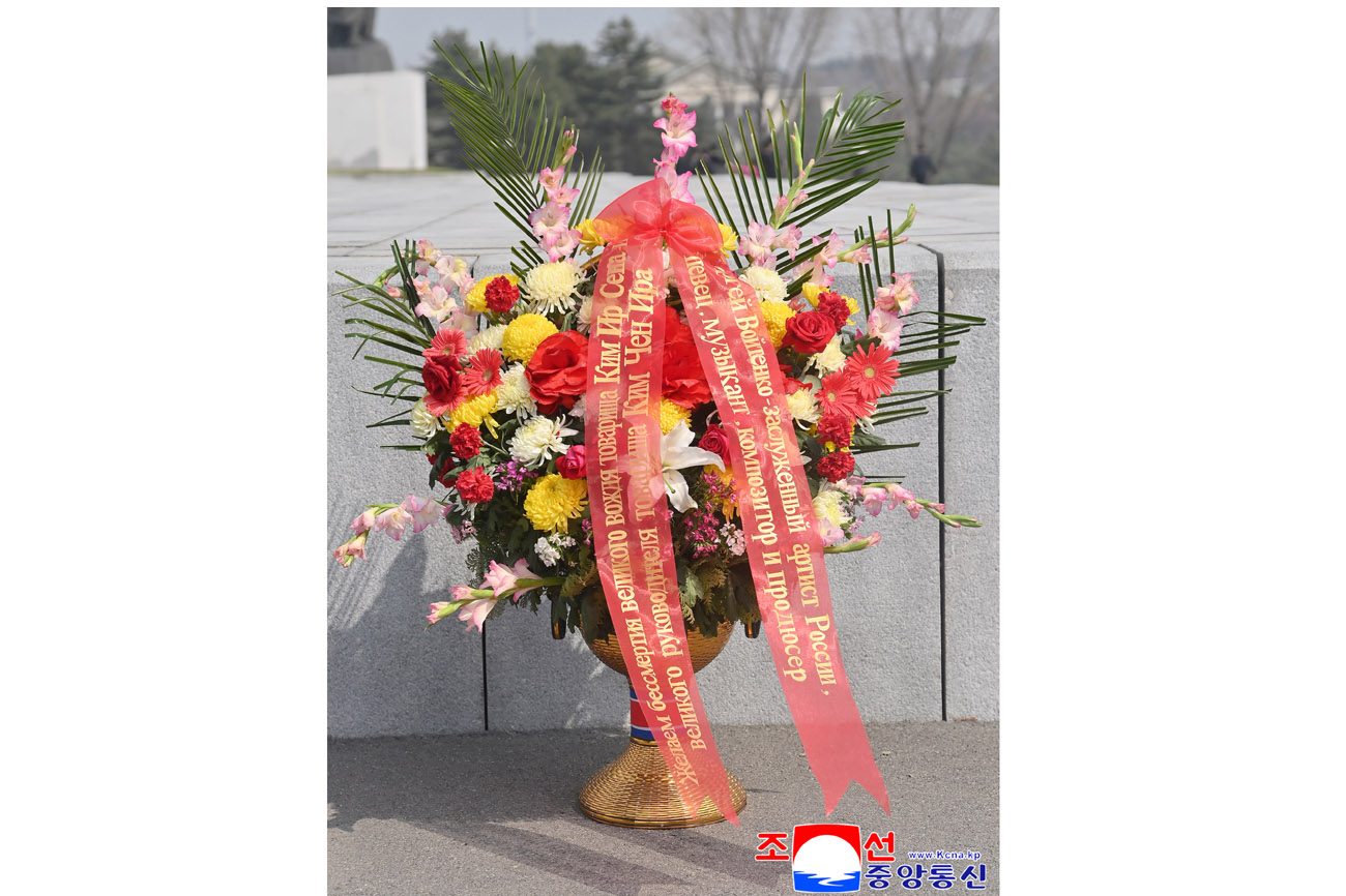 Floral baskets laid before bronze statues of great leaders Kim Il Sung and Kim Jong Il