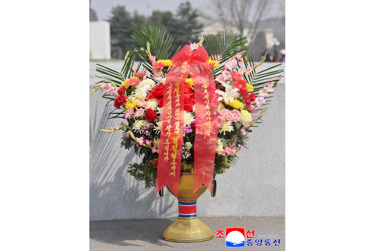 Floral baskets laid before bronze statues of great leaders Kim Il Sung and Kim Jong Il